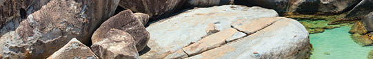 Family of mother and kids enjoying view of beautiful scenery of The Baths beach area major tourist attraction at Virgin Gorda, British Virgin Islands, Caribbean