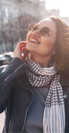 Young stylish woman wearing gray maxi dress and leather jacket walking on the city street in spring  Casual look, elegant style  Plus size fashion outfit 