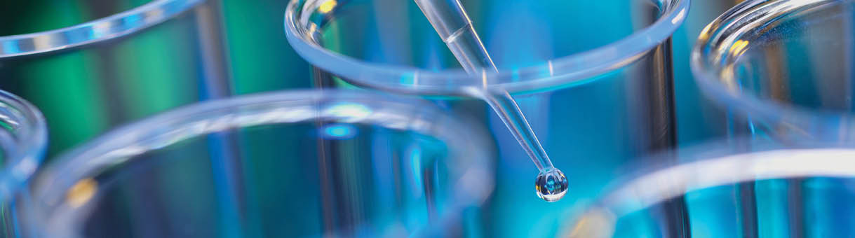Analytical chemistry - sample being pipetted into test tube for analysis in laboratory